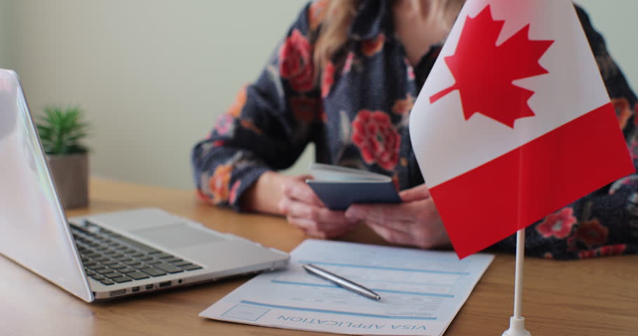 Canadian woman consular officer giving passport to male immigrant, work visa, citizenship. Visa Application online form immigration concept. Visa approval. Royalty-Free Stock Footage #1100561869