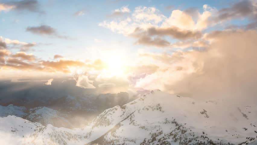 Snow and Cloud covered Canadian Mountain Landscape Nature Background. Dramatic Sunset Sky Art Render. Cinemagraph Continuous Loop Animation. Near Vancouver, British Columbia, Canada. Aerial | Shutterstock HD Video #1100561953