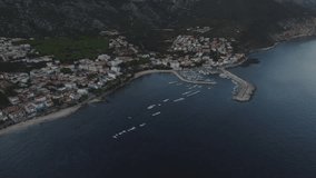 Drone Video, Flying above the harbour in Sardinia, calm sea at sunset