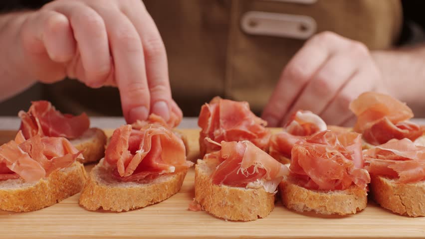 Jamon iberico tapas close up, chef cooking the best spanish ham pork tapas, cafe with traditional food. | Shutterstock HD Video #1100563977