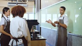 Male Teacher Explain to Students During Lesson About Project and Writting to Whiteboard. He explain equation point at whiteboard stand in classroom. Education, Chef, Learning, Lifestyle, Teching conce - Powered by Shutterstock - Get 15% off with code: PIKWIZARD15