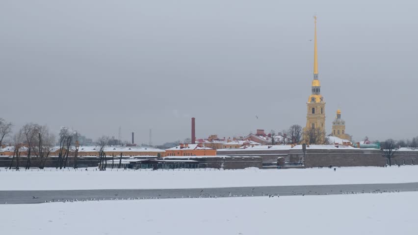 Video of the Peter and Paul Fortress, the original citadel of St. Petersburg on Hare Island in winter with the gulls flying over the ice-free water line of Neva river. Saint Petersburg, Russia