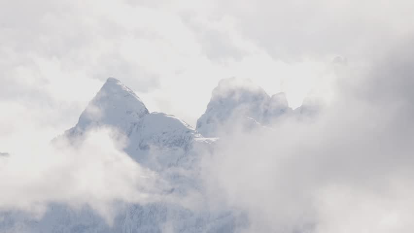Snow and Cloud covered Canadian Nature Landscape Background. Winter Season in Squamish, British Columbia, Canada. Sunny Sky. Slow Motion
