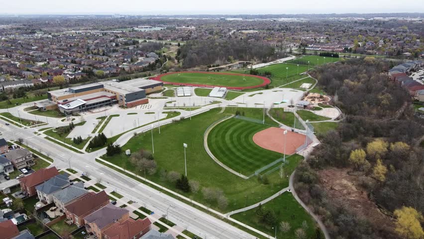 Aerial shot circling over baseball diamond in spring.