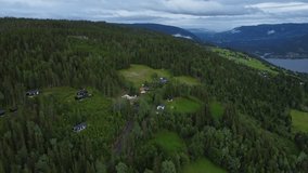 Stunnning aerial of houses next to forest and fjord in Norway