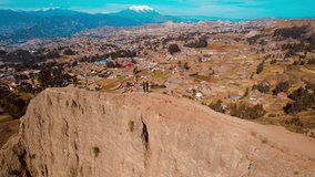 Aerial video over Vale de la Luna Bolivia, a tourist place near La Paz on a sunny day. People are standing on the cliff