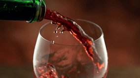 Super slow motion of pouring red wine into glass with speed motion. Filmed on high speed cinema camera , 1000 fps, placed on high speed cine bot. - Powered by Shutterstock - Get 15% off with code: PIKWIZARD15