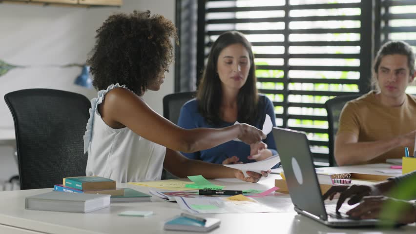 Motivated black female team leader explaining company development strategy to smiling young diverse colleagues. Happy multiracial business people enjoying working together at office.
 Royalty-Free Stock Footage #1100580133