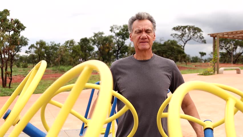 Slow Motion of a Mature Man finishing his work out on a Tai Chi Spinner Machine