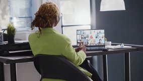 Executive assistant talking on remote video call at desk, meeting with business people online on videoconference chat. Team of coworkers planning growth on internet teleconference. Handheld shot. - Powered by Shutterstock - Get 15% off with code: PIKWIZARD15