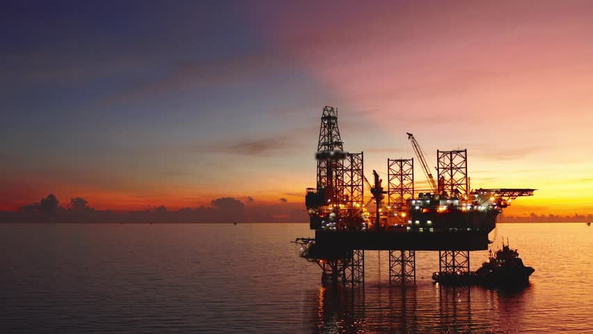 Jack up drilling rig and production platform in the middle of the ocean at sunrise time
 Royalty-Free Stock Footage #1100583545