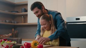 Father teaching Caucasian kid daughter cut fresh vegetable salad in kitchen cooking happy family together. Parent dad learning small child girl cook healthy food help with cutting cucumber for meal - Powered by Shutterstock - Get 15% off with code: PIKWIZARD15