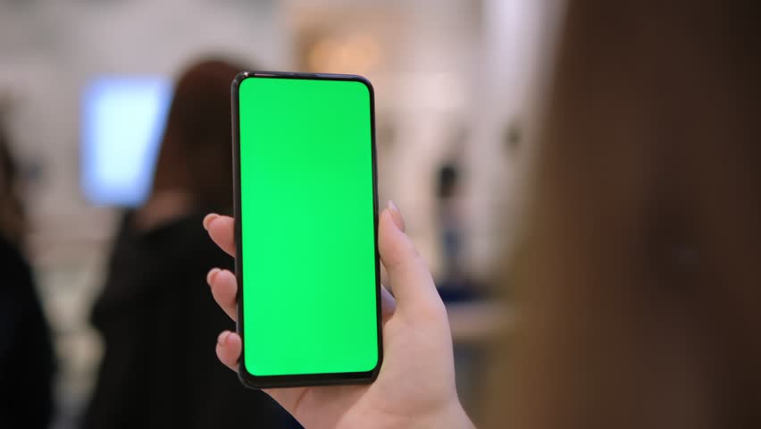Mall. Use green screen for copy space closeup. Chroma key mock-up on smartphone in hand. hold mobile phone and looking photos or pictures | Shutterstock HD Video #1100586029
