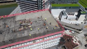 Drone view Of building and Construction workers. Highway traffic in City.