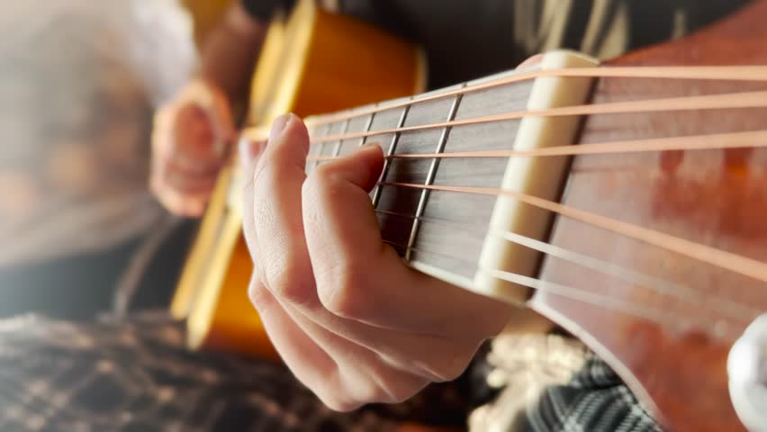 Classic guitar girl play. musician jazz acoustic a instrument concept. guitarist country girl hands close-up plays at the window indoors. learning to play the guitar lifestyle Royalty-Free Stock Footage #1100592647