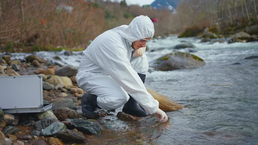 scientist biologist test of water in a reservoir check of pollution environmental problem