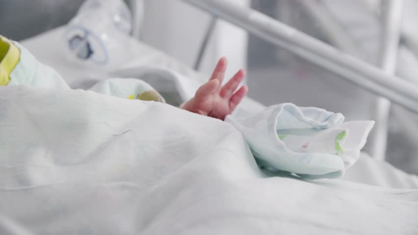 Lovely little newborn baby infant lying in incubator for newborns. Concept of New Life. Newborn baby  in NICU, Neonatal intensive care unit.  Royalty-Free Stock Footage #1100598677