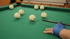 Slow motion video game of pool billiards, cue that hits the ball on the pool table. 