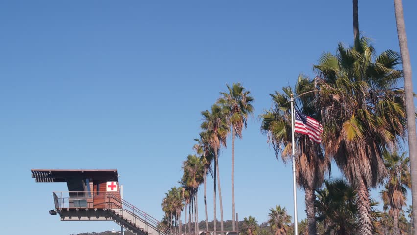 Lifeguard stand or life guard tower hut, surfing safety on California beach, USA. Summer pacific ocean aesthetic. Rescue station, coast lifesavers wachtower or house, palm trees in La Jolla, San Diego