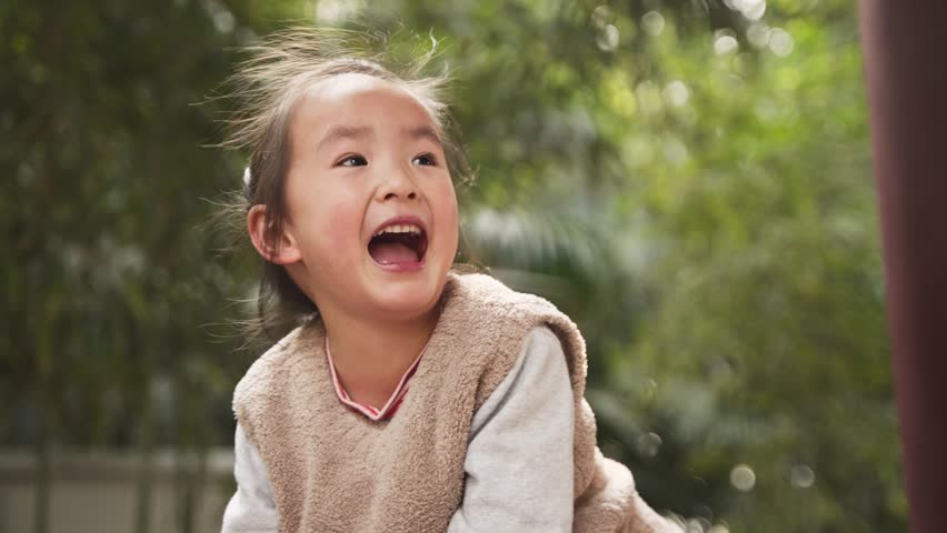 Lovley little asian girl laugh outdoor in the sunny park slow motion 4k clip | Shutterstock HD Video #1100611335