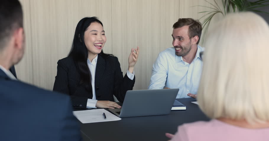 Young, ambitious team negotiate meet in company office boardroom, Asian businesswoman, share information, convinces to company clients, make speech, discuss commercial deal, take part in group meeting Royalty-Free Stock Footage #1100614277