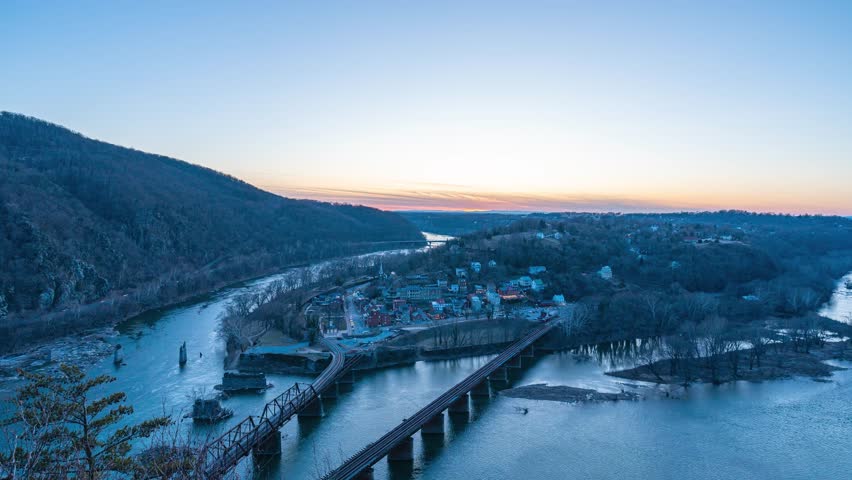 A 4k time lapse of downtown Harpers Ferry during a winter sunset from a scenic overlook.