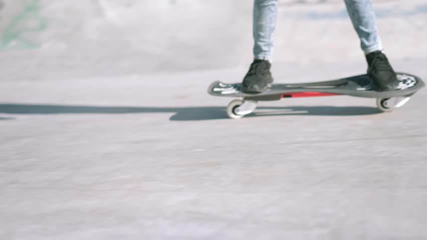 Legs on waveboard close up, Girl riding on casterboard with two wheels, modern street skate sports of teenagers, ripstick for balance ride.
