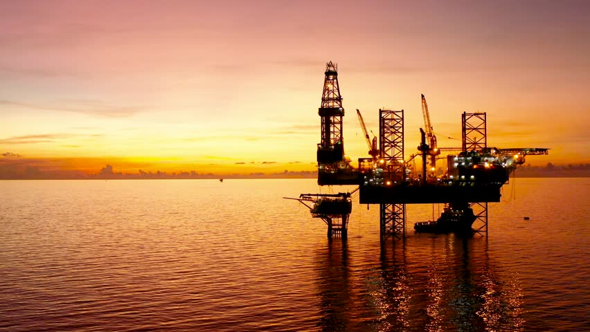 Jack up drilling rig and production platform in the middle of the ocean at sunrise time
 Royalty-Free Stock Footage #1100619015