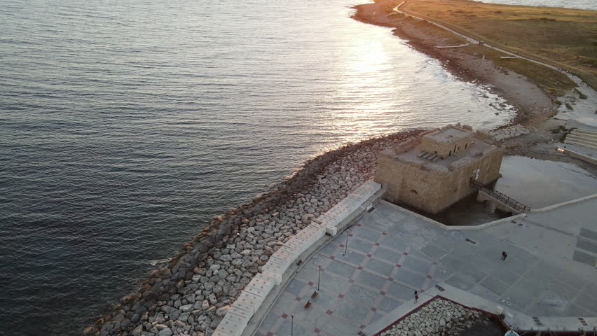 Aerial Panoramic view of Pafos Castle against the setting sun, Cyprus