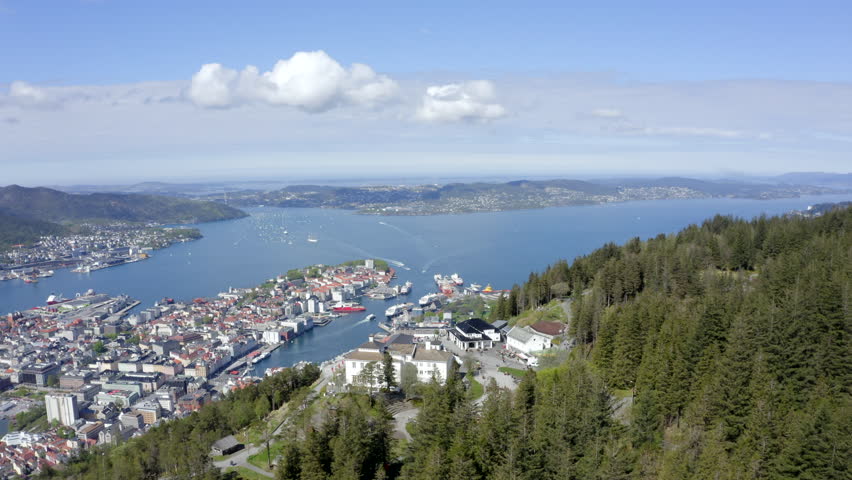 Beautiful drone shot of Bergen, Norway, from above Mount Fløyen. Magnificent view of the city and the restaurant on top of the mountain. | Shutterstock HD Video #1100620049