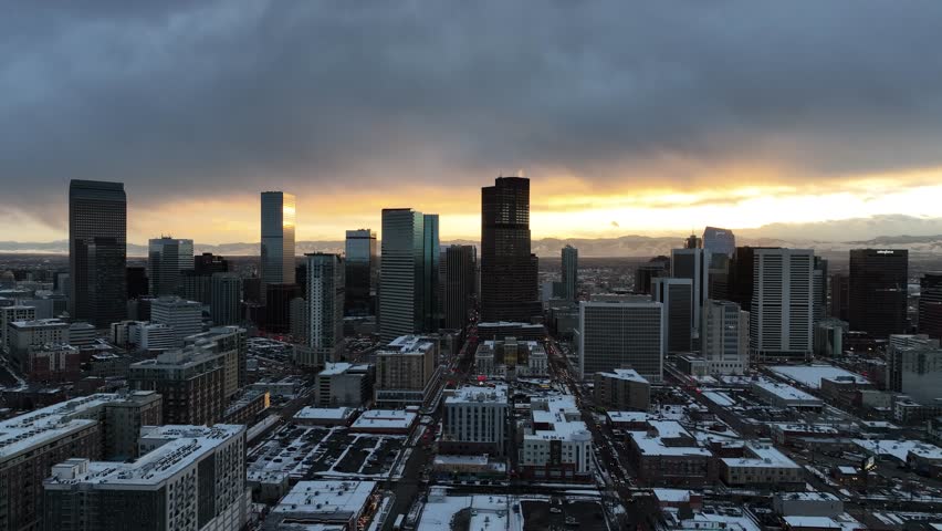 Aerial view of downtown Denver, Colorado covered in a blanket of snow at sunset.