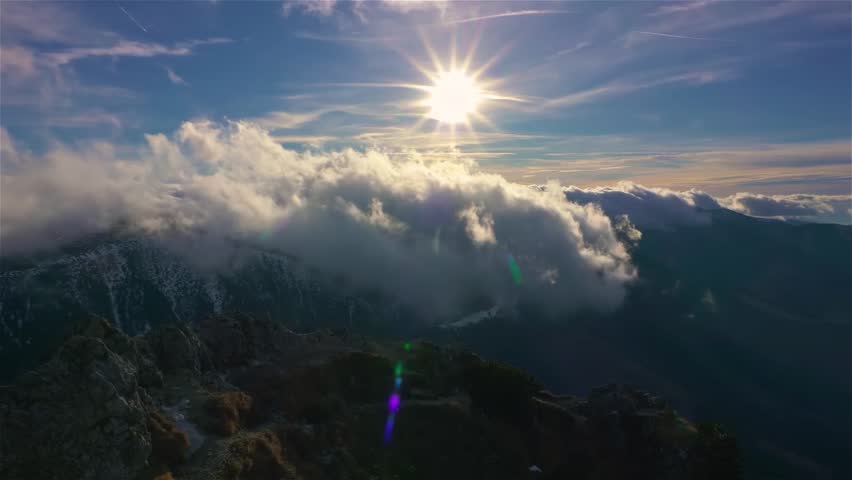 Sunny day in spring mountains with foggy clouds motion fast over ridge, outdoor tourism background
 | Shutterstock HD Video #1100621625