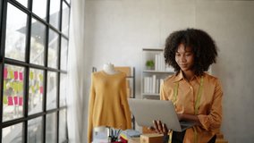 Female African designer is dressmaking the new clothes in workspace.  - Powered by Shutterstock - Get 15% off with code: PIKWIZARD15