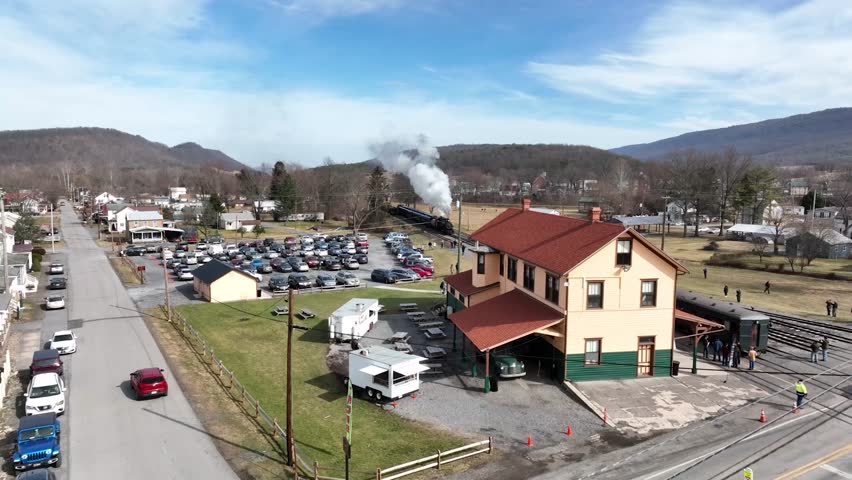 Steam engine train vintage locomotive with passenger cars railroad Spring Summer Fall 4K Aerial Drone Helicopter Flyover