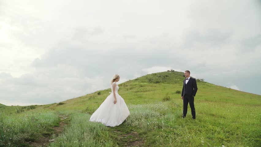 Affectionate Young Couple Slow Dance in a Field Together