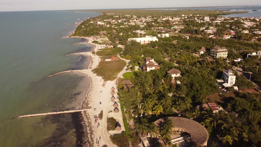 Isla de Holbox is a small, laid-back island off the coast of Mexico's Yucatan Peninsula. Its pristine beaches, colorful houses, and diverse wildlife make it a popular destination for travelers. Royalty-Free Stock Footage #1100631919