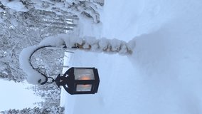 Vertical. Handhold shot of a lantern with a burning candle in a snowdrift. - Powered by Shutterstock - Get 15% off with code: PIKWIZARD15