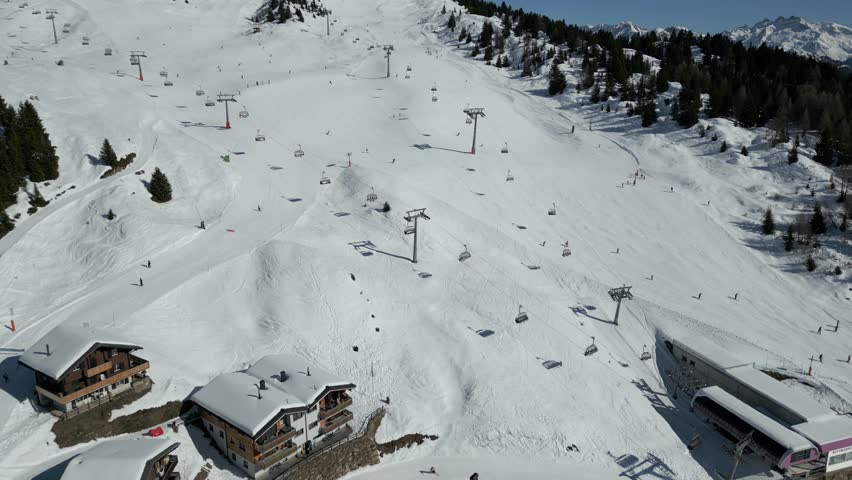Bettmeralp in the Aletsch Arena. Full operation in winter with ski lift and chairlifts. Skiers ski down the slopes