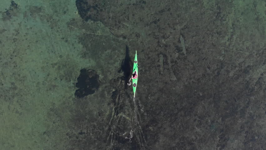 AERIAL - Person on canoe on Hermoso Lake, Neuquen, Argentina, top down forward