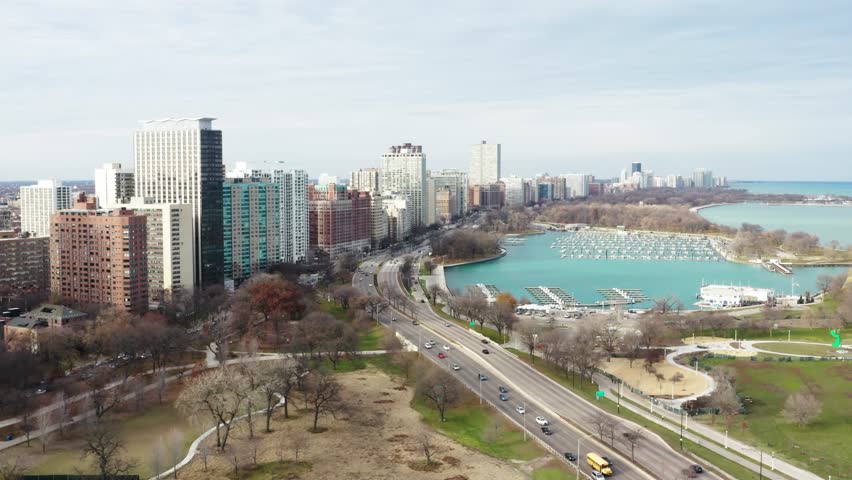 Chicago lakeshore apartments and condominiums, empty Belmont Harbor, US Highway 41 and S Dusable Lake Shore Drive; aerial view parallel to the road in cold autumns day