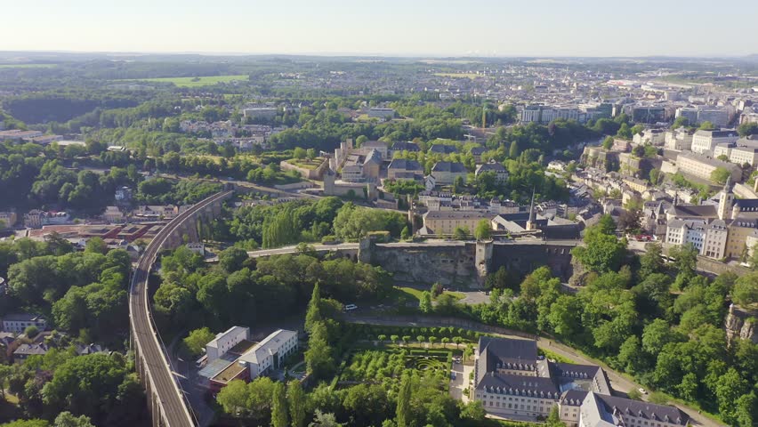 Inscription on video. Luxembourg, Historical city center in the morning. Arises from blue water, Aerial View
