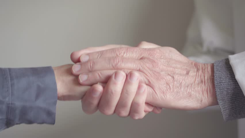 Mature male doctor hand comforting female patient | Shutterstock HD Video #1100644669