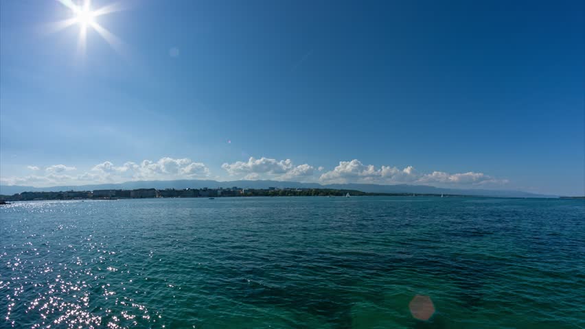 Time-lapse movement of clouds. Panoramic view to the shore of Lake Geneva and Geneva city, Switzerland.