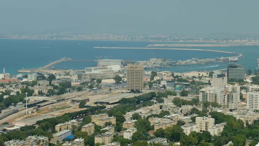 The camera is panning back and forth, revealing the view of downtown Haifa and the marine port from the Carmel mountain above, Israel.