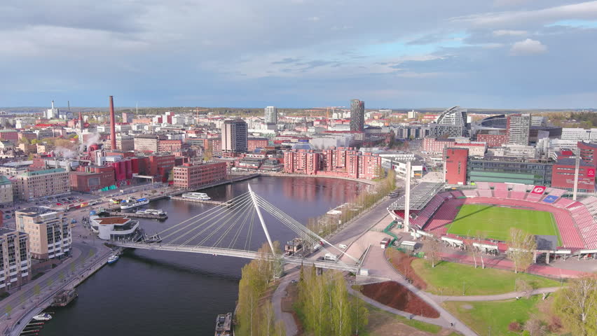 Tampere, Finland: Aerial view of Nordic city in spring, dark waters of adjacent lake - landscape panorama of Northern Europe from above