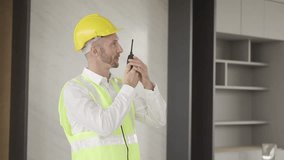 Engineers use walkie-talkies to communicate with crews while working in a factory. Foreman gives work instructions, talks using a walkie-talkie, works at a construction site. - Powered by Shutterstock - Get 15% off with code: PIKWIZARD15