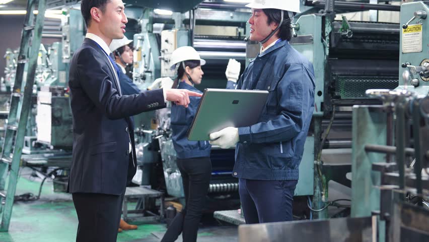 Engineers working in a factory Royalty-Free Stock Footage #1100650257