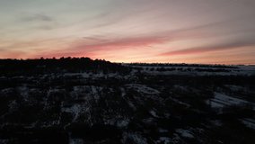 Sunset over the snowy field with Mountains on a background(Ungraded, Original Footage)