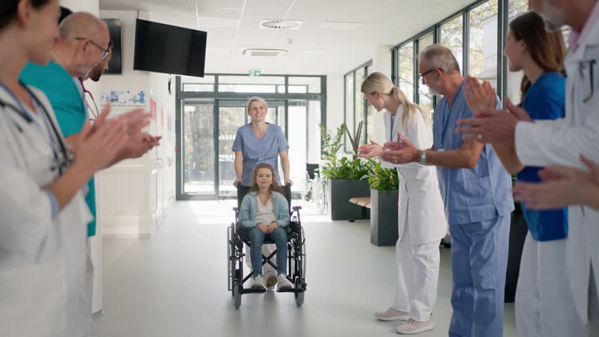 Medical staff clapping to little girl patient who recovered from serious illness. Royalty-Free Stock Footage #1100654515