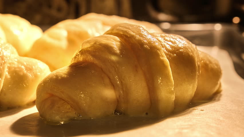 Homemade croissants baking in kitchen oven. Timelapse of freshly baked croissants. French bakery concept. Yummy pastry. Homemade bakery. Breakfast. Croissants rising up in oven. Close-up in 4K, UHD Royalty-Free Stock Footage #1100655403